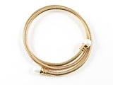 Modern Wraparound With Pearl Ends Gold Tone Steel Bangle