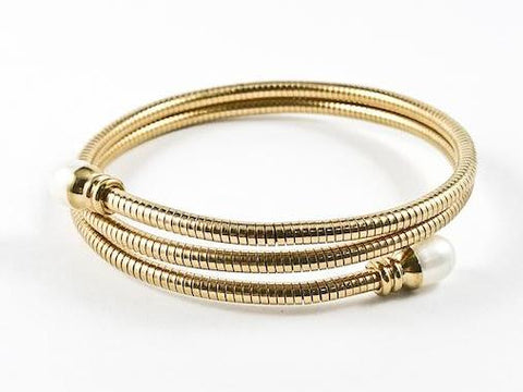 Modern Wraparound With Pearl Ends Gold Tone Steel Bangle